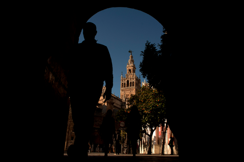 A man walks past next to the Giralda of Sevilla. AFP PHOTO/ JORGE GUERRERO